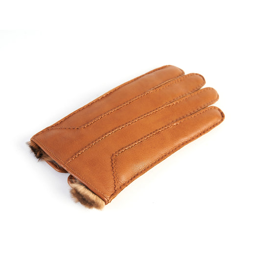 Cognac leather glove featuring elegant stitching and soft fur lining, showcasing Italian craftsmanship and luxurious design.