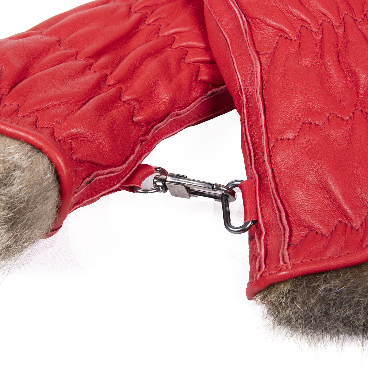 Red leather women's ski gloves featuring a plush fur lining and a secure clip for added convenience and style.