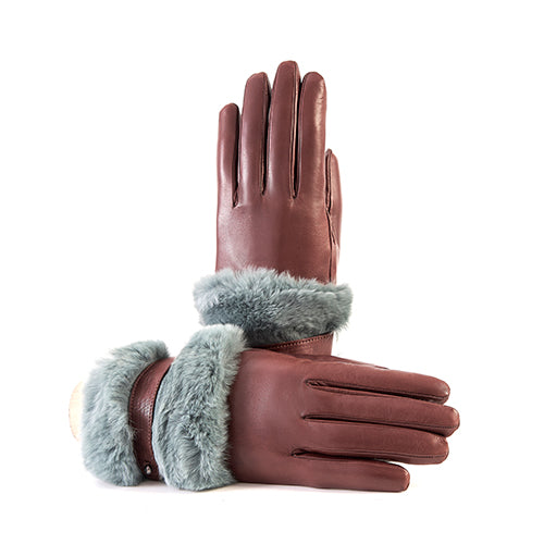 Ladies' burgundy nappa leather gloves featuring a large soft blue fur cuff and strap, lined with luxurious cashmere.