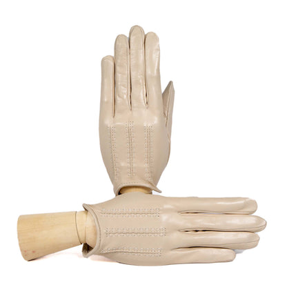 Beige unlined leather gloves showcasing elegant stitching, embodying Italian craftsmanship and timeless style for spring.