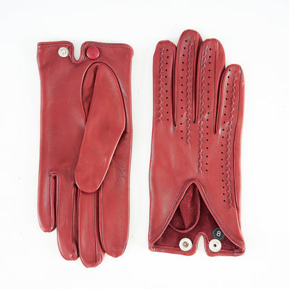 Red leather driving gloves featuring elegant perforations and a stylish button closure, showcasing Italian craftsmanship.