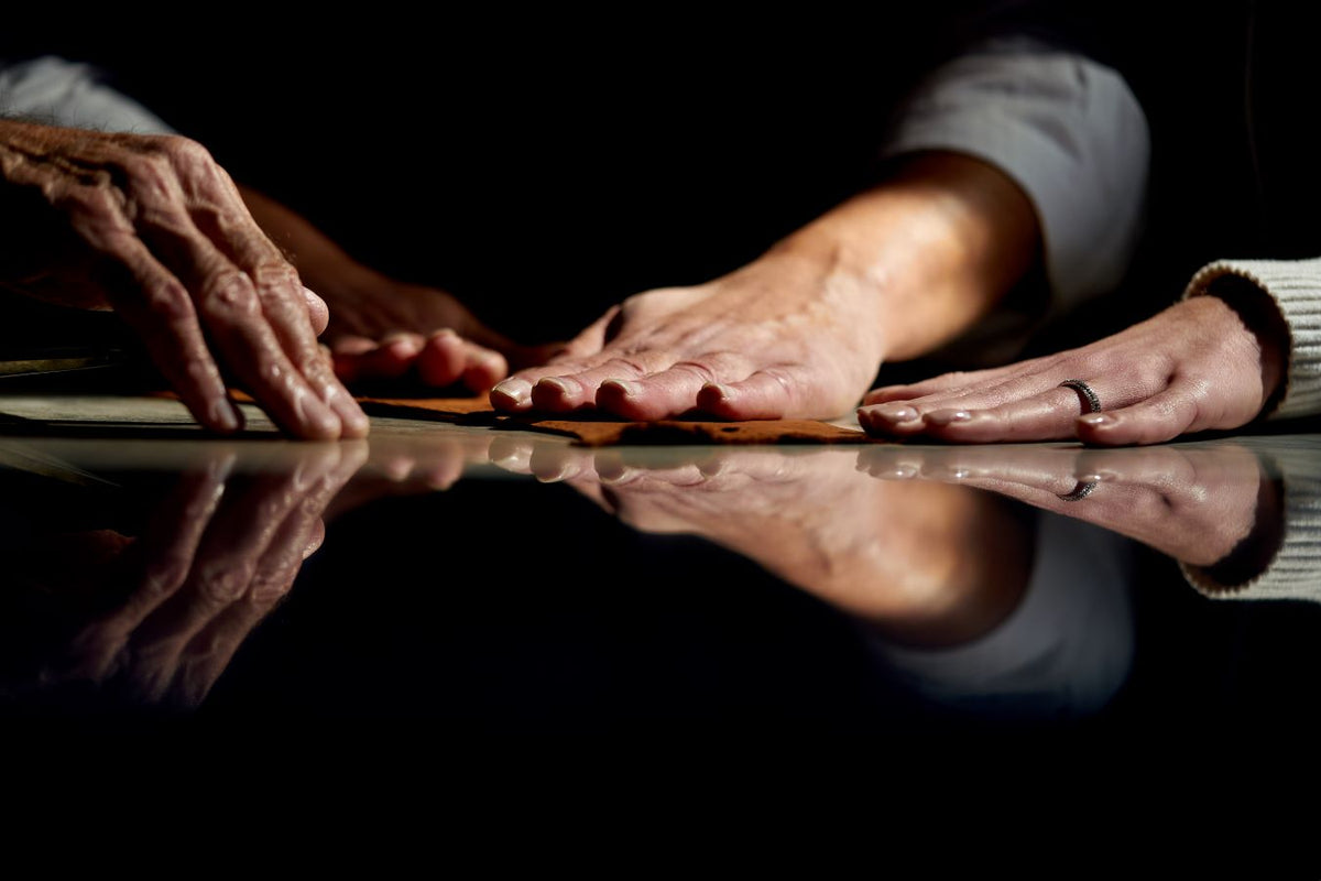 Hands gently pressing on premium leather, reflecting the elegance of Italian craftsmanship in glove making.