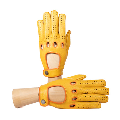 Men's yellow deerskin driving gloves featuring snap closure and contrast orange details, showcasing Italian craftsmanship and style.