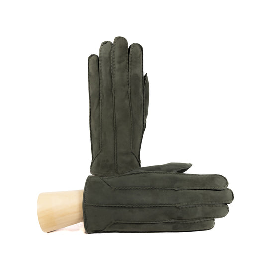 Handcrafted dark green suede leather gloves with elegant stitching, showcasing Italian craftsmanship and luxurious design.